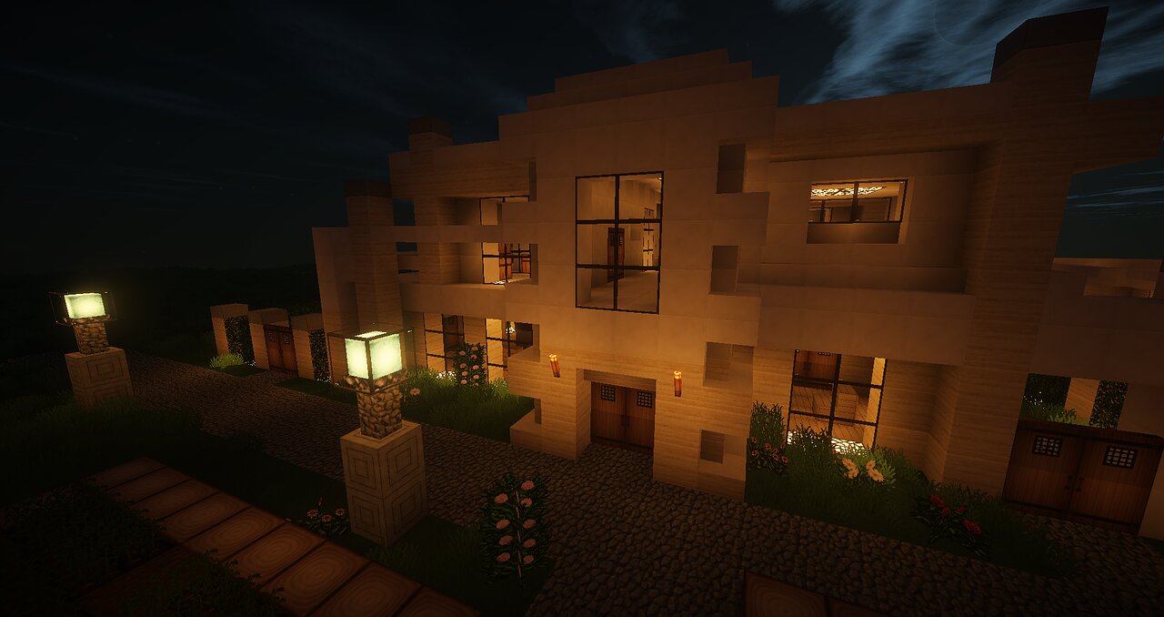 A modern Minecraft house build lit up at night